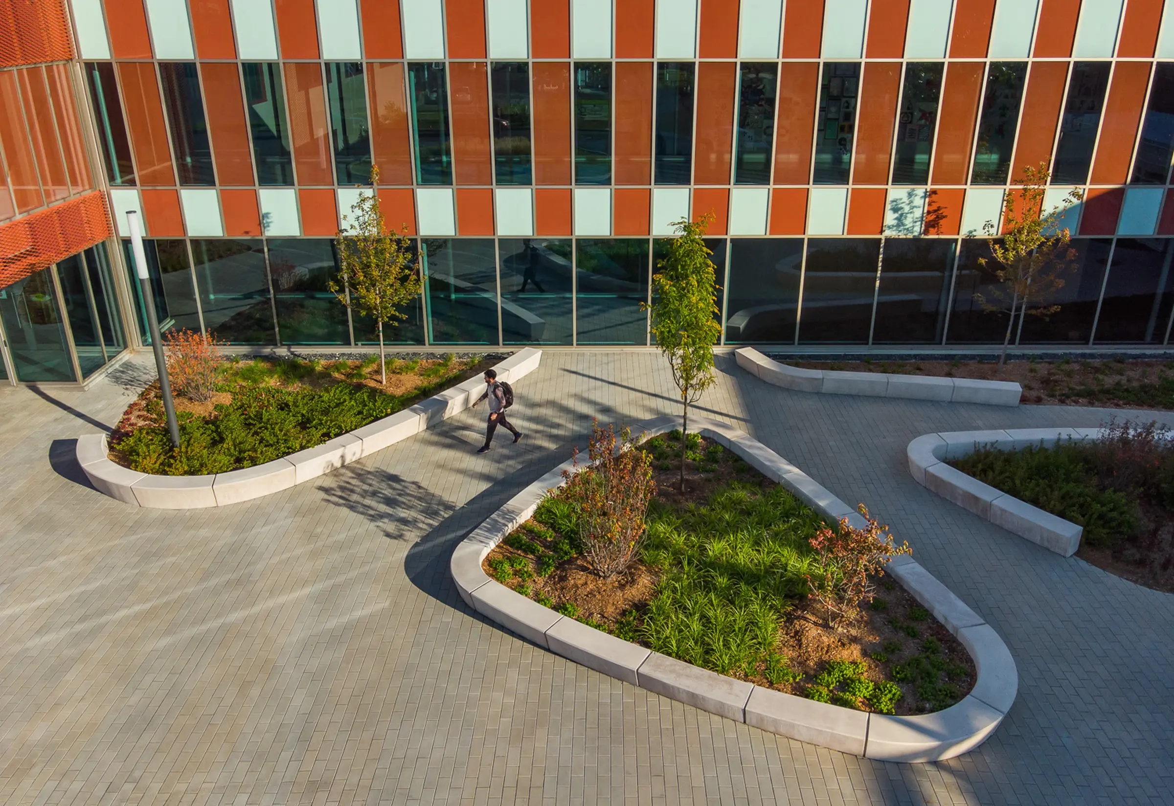Multiple green islands at the entrance of Collège Charles-Lemoyne