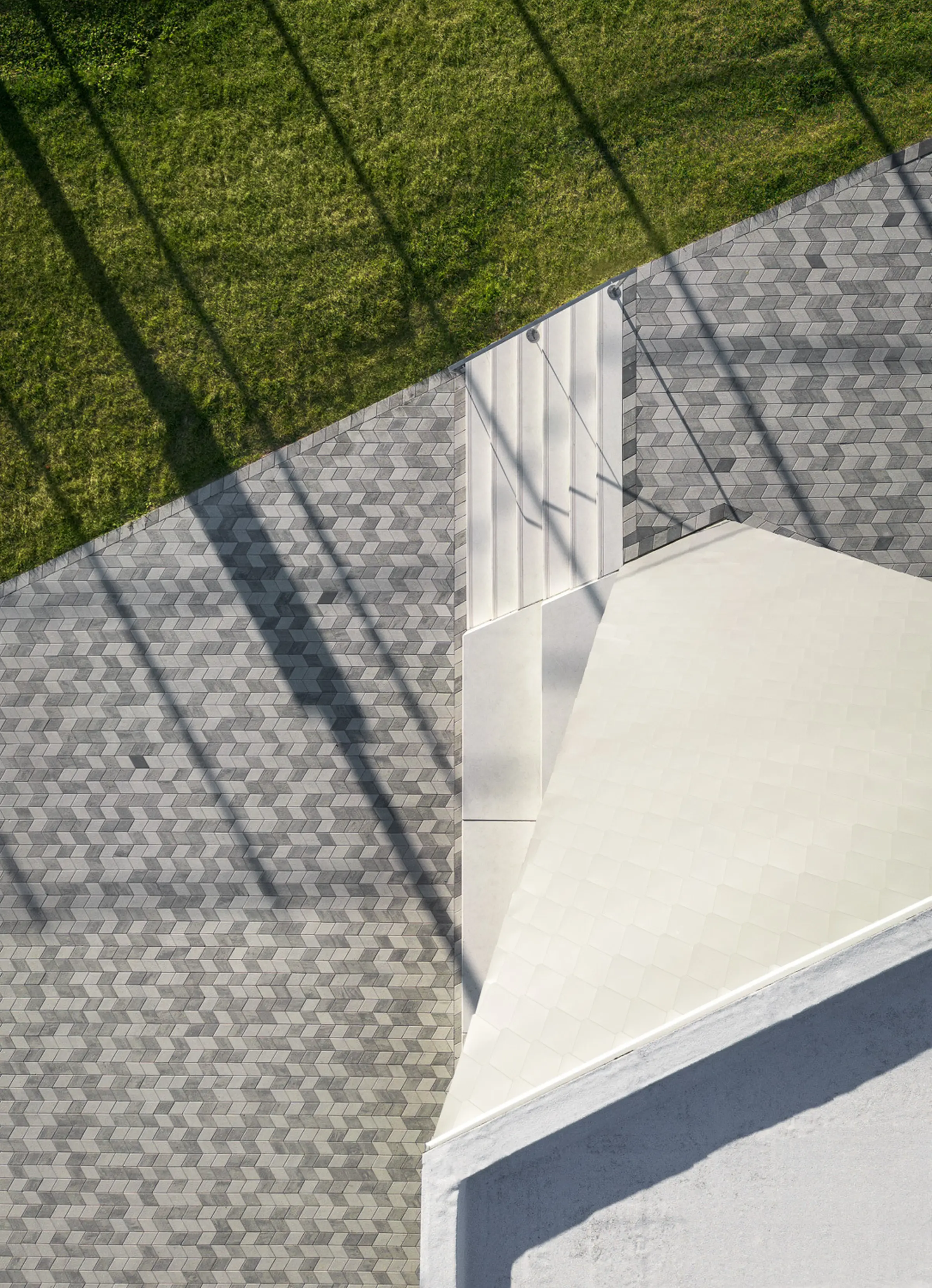 White-toned concrete slabs and grey-paved pathways